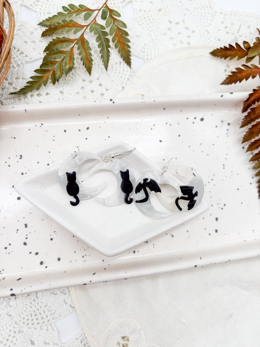 Moon dangles with black cat or dragon