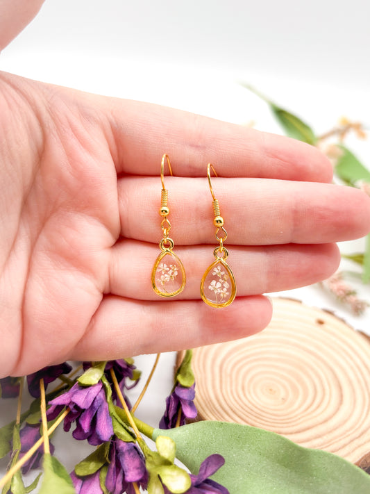 Tiny gold plated teardrops with white pressed flowers