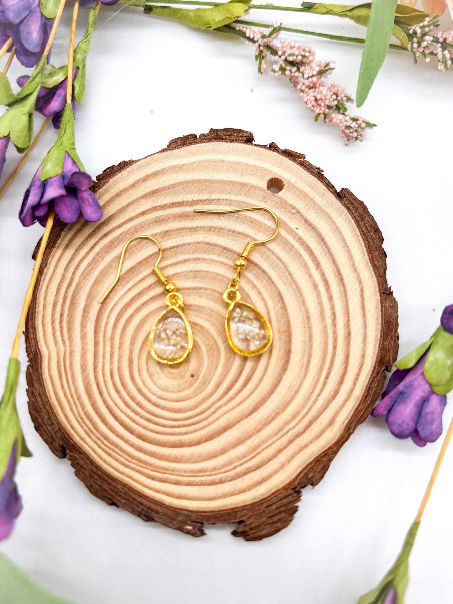 Tiny gold plated teardrops with white pressed flowers