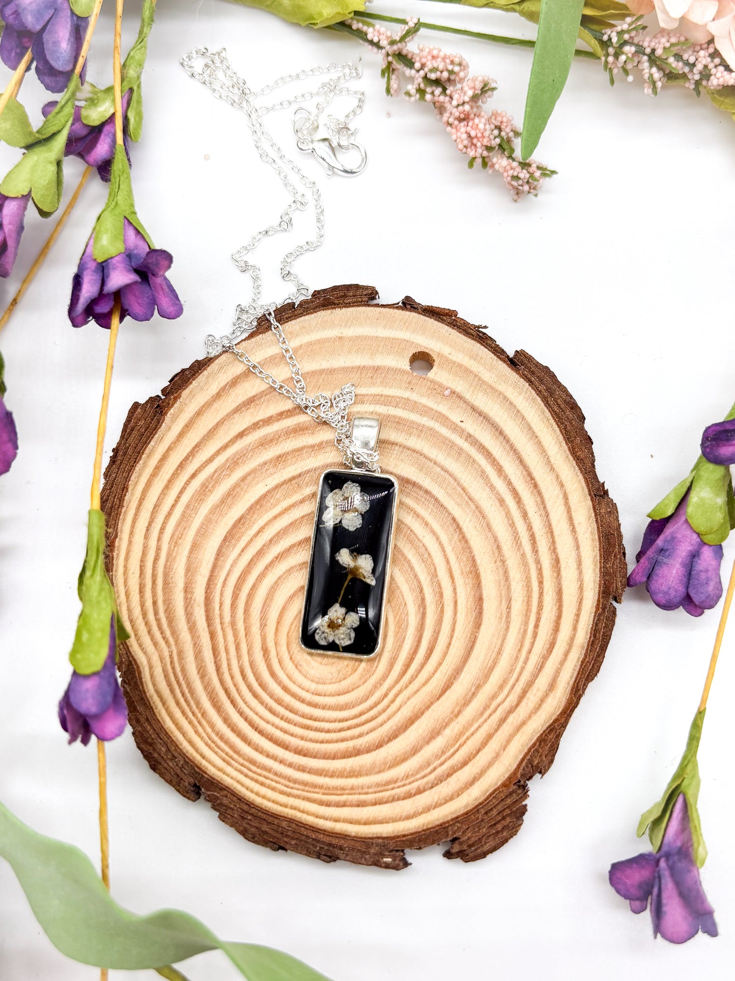 Black pendant with white flower necklace