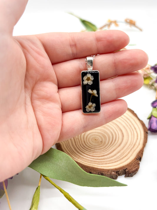 Black pendant with white flower necklace