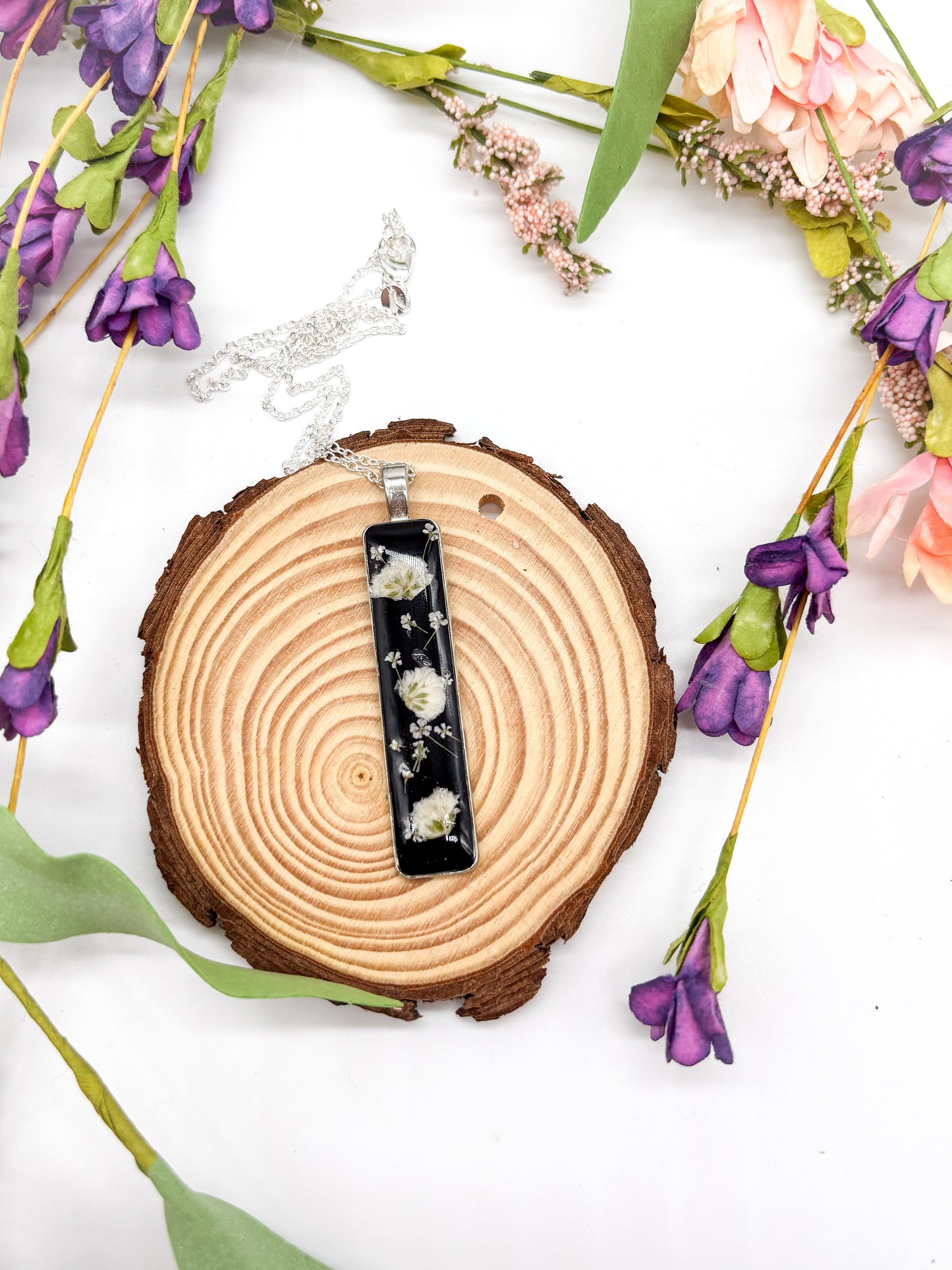 Silver plated necklace with Long black pendant with white flowers