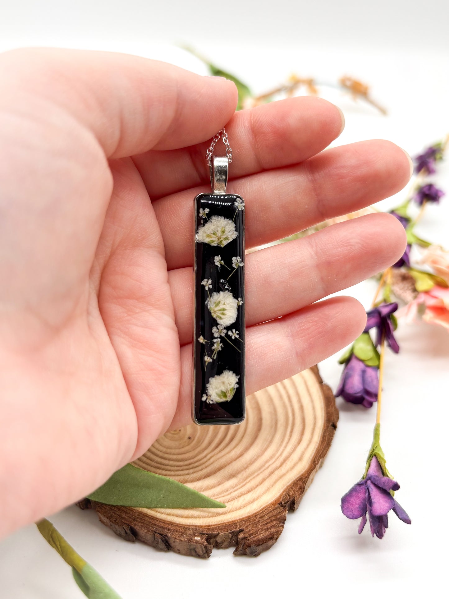 Silver plated necklace with Long black pendant with white flowers