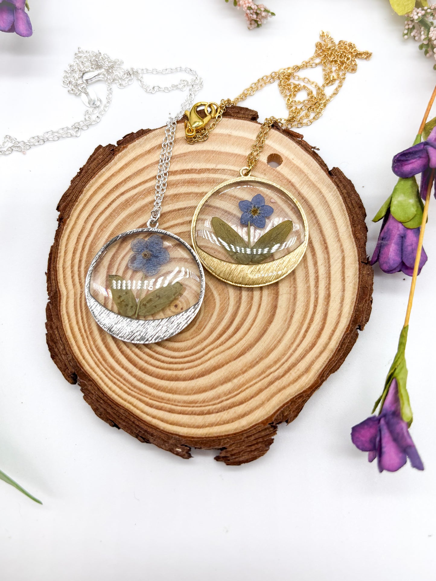 round pendant with forget me not flower