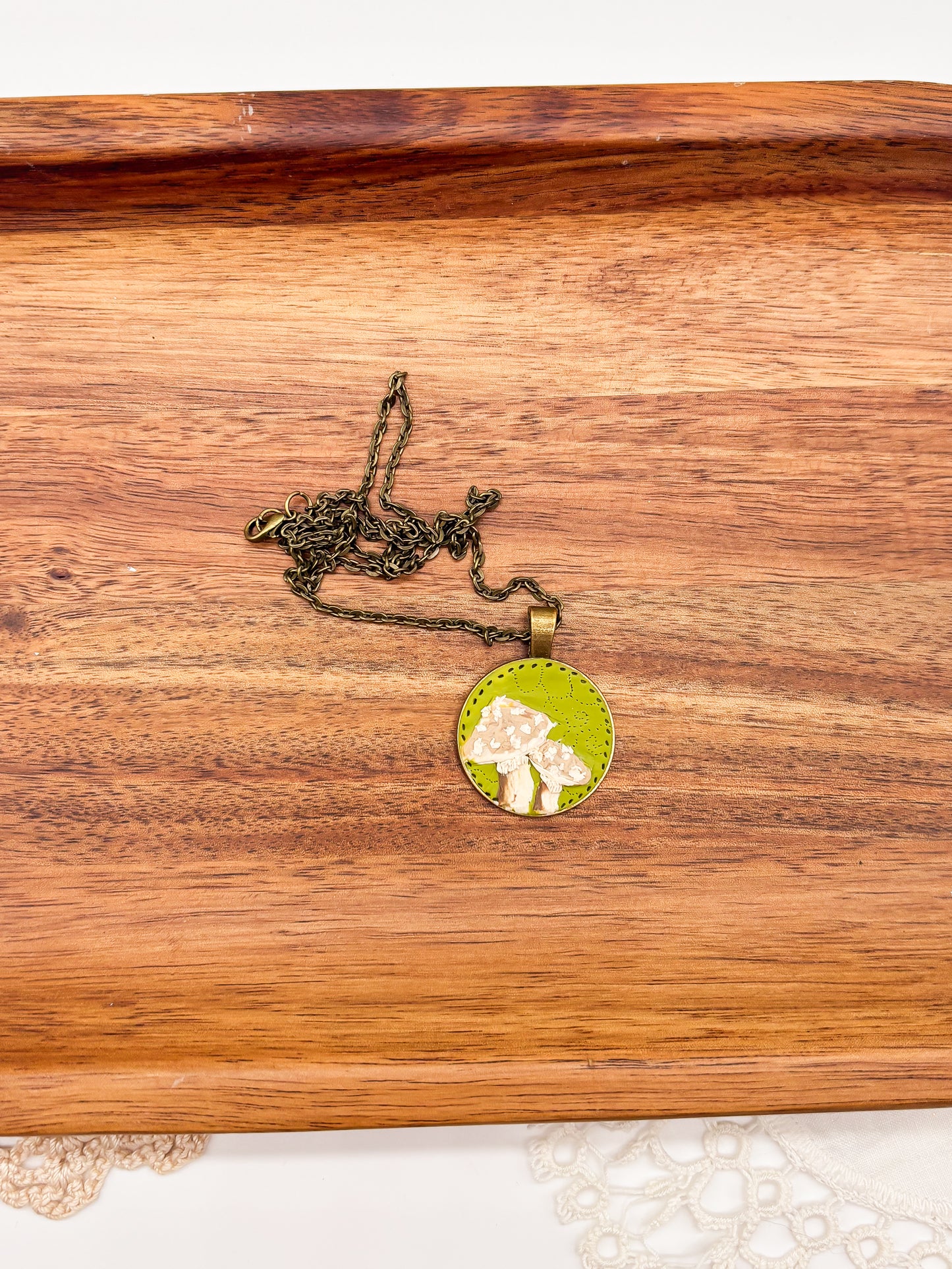 Neutral mushroom on green background necklace