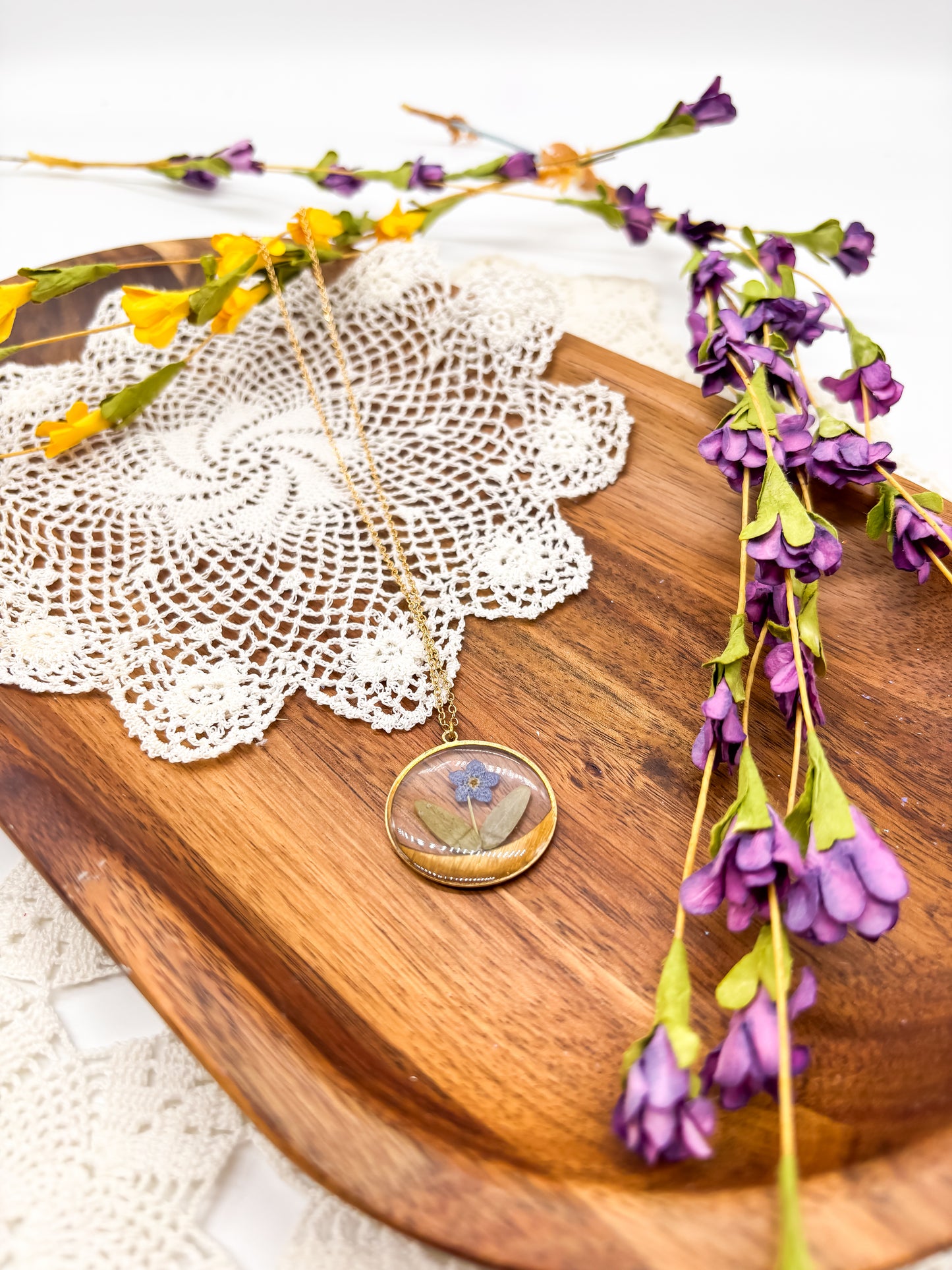 round pendant with forget me not flower