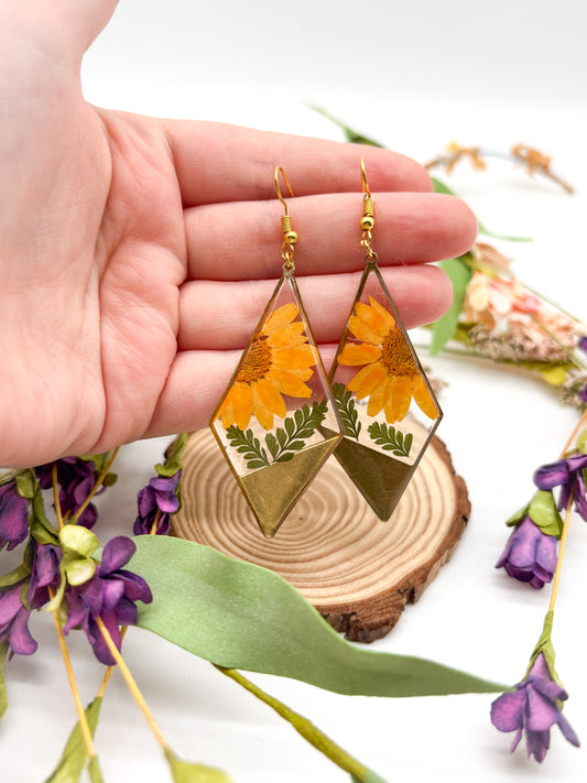 Diamond shaped earrings with orange daisies