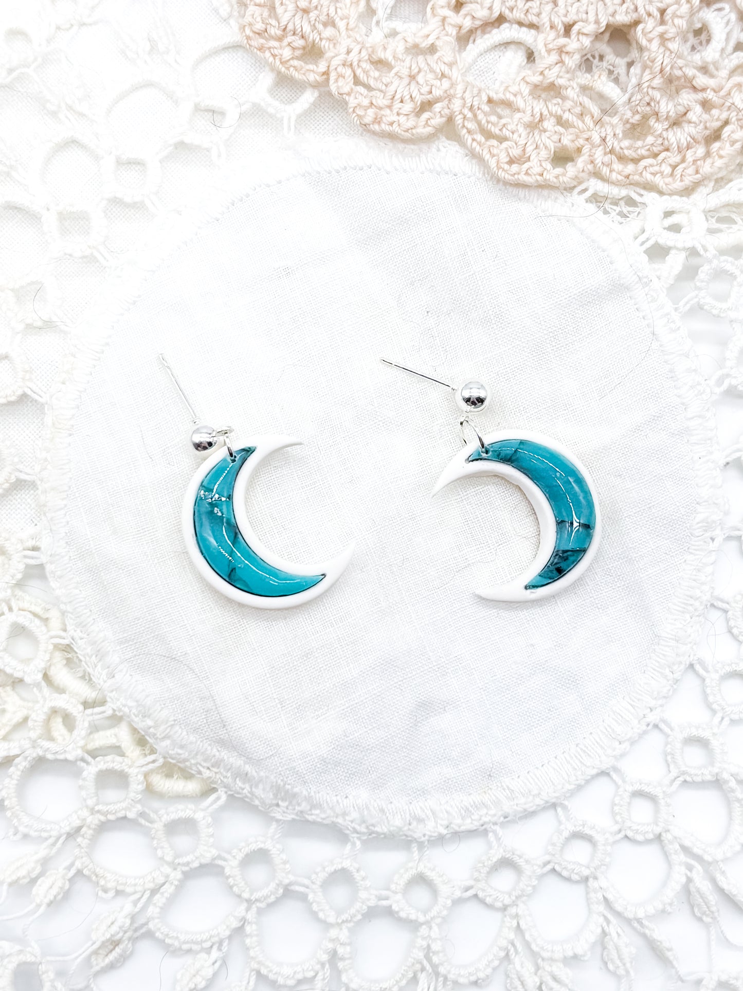 Turquoise moons in white clay bezel