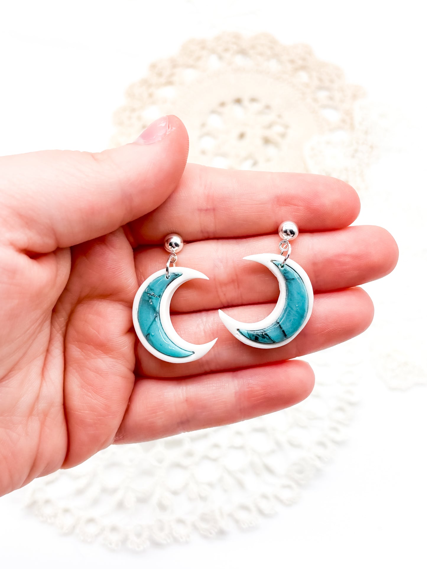 Turquoise moons in white clay bezel