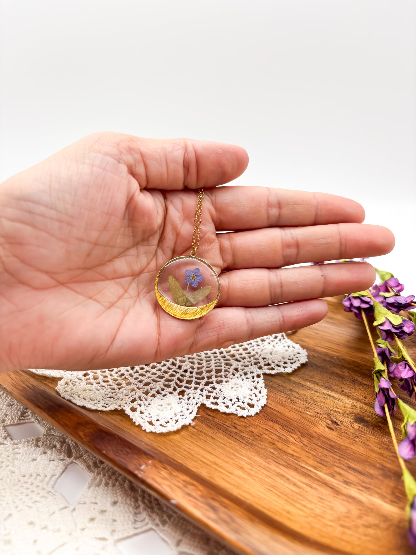 round pendant with forget me not flower